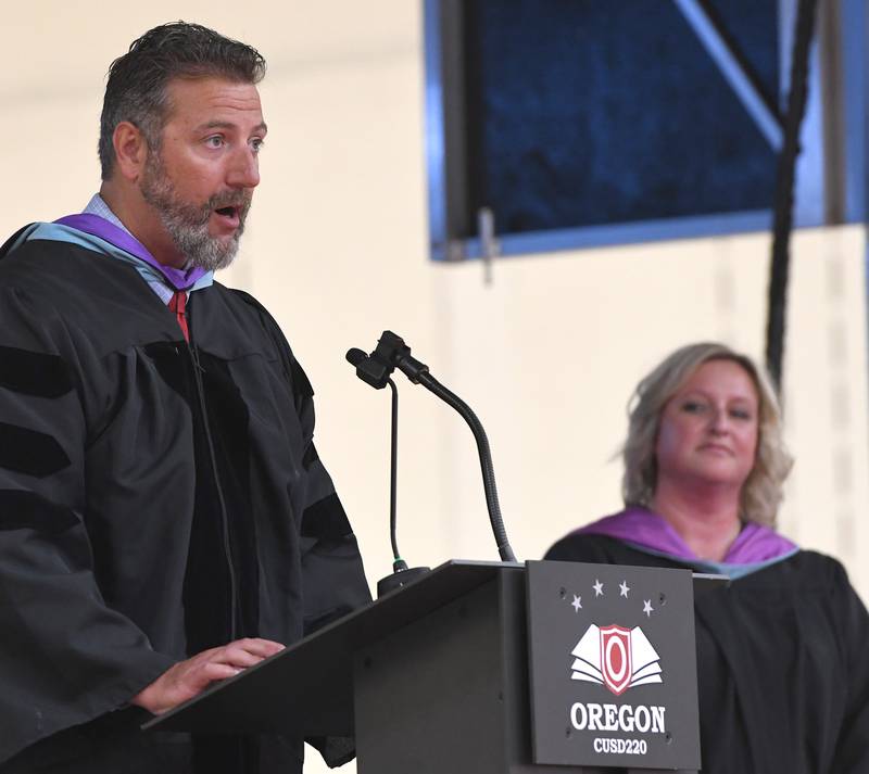 Oregon School District Superintendent PJ Caposey addresses the Class of 2026 as Oregon High School Principal Jen Speakes listens during the commencement ceremony on Sunday, May 24, 2026 at the Blackhawk Center in Oregon.