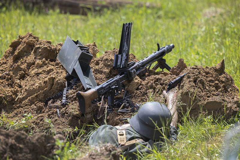 Troops take cover Saturday, May 16, 2026, during a reenactment of the Battle of Anzio in Franklin Grove.