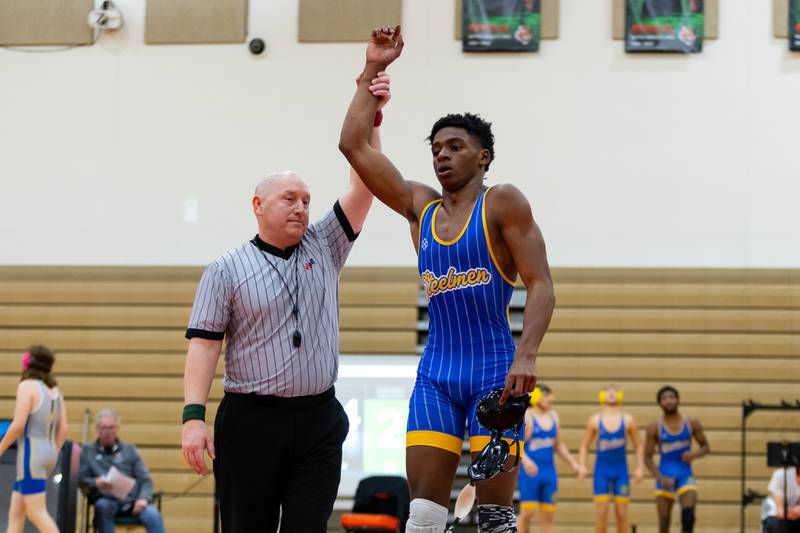 Mark Bew of Joliet Central defeats Plainfield East's Colin Adams in the 157-pound match at Plainfield East on Dec. 12, 2024.