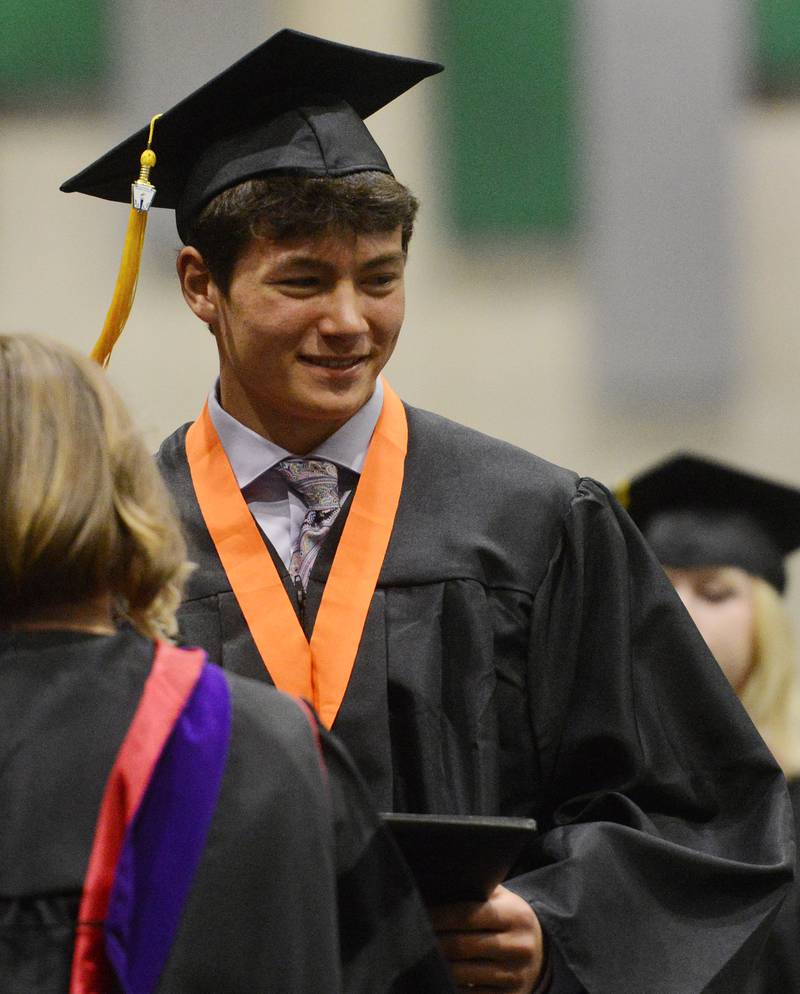 Joe Lewnard/jlewnard@dailyherald.com
Charlie Butt receives his diploma during the Wheaton Warrenville South High School graduation, held at the College of Dupage in Glen Ellyn Saturday.