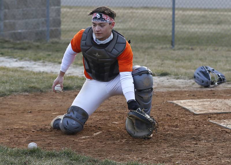 McHenry baseball player Cooper Cohn fields a throw to home plate during baseball practice Wednesday, March 8, 2023, at Petersen Park in McHenry.