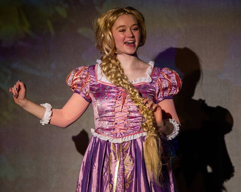 'Repunzel' (portrayed by Olivia Bergfeld) sings whilst holding ponytail during performance of "New Year, New Friends" on Saturday, December 27, 2025 at Stage 212 in LaSalle.