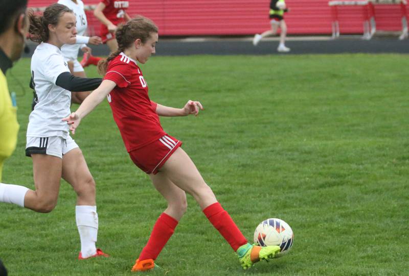 Ottawa's Kindley Moore kicks the ball ahead of L-P's Amelia Buckley on Wednesday, April 30, 2025 at King Field in Ottawa.