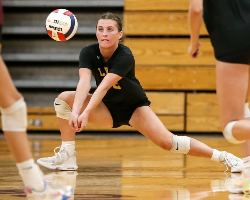 Lyon's Reagan Farnan (8) attempts a dig save during volleyball match between Lyons at Lockport.  Aug 27, 2024.
