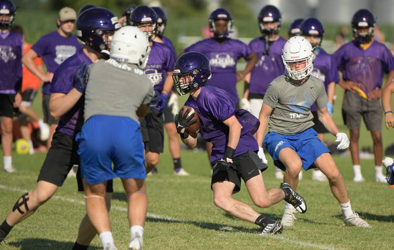 Dixon offense runs with the ball against Burlington Central during a 7 on 7 football in Maple Park on Tuesday, July 12, 2022.