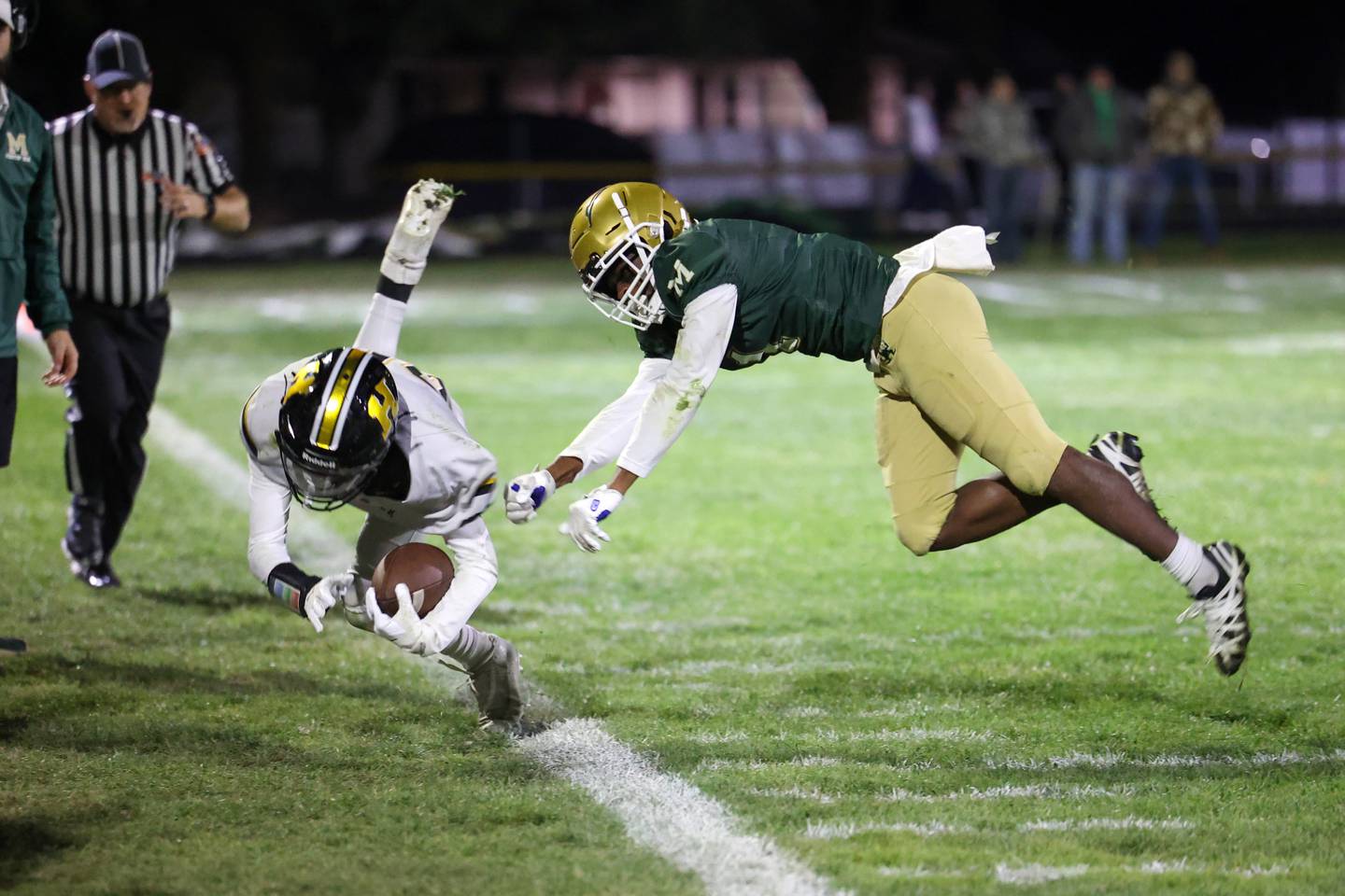 Bishop McNamara's Malachi Lee forces Herscher's Mason Roberts out of bounds during Bishop McNamara's 38-14 victory in the IHSA Class 3A first round playoff game on Friday, Oct. 31, 2025.