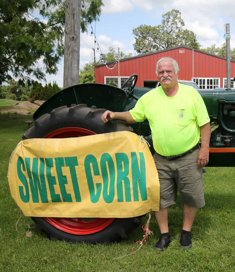 Rob Wessels, owner of Wessels’ Family Farm, with his tractor Thursday, July, 18, 2024, at the market in DeKalb.
