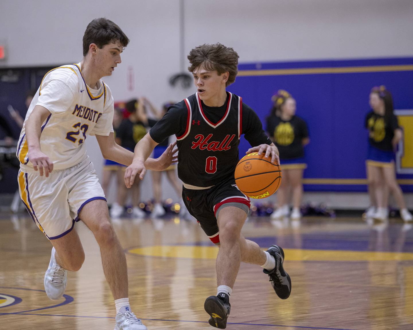 Greyson Bickett of Hall High School runs the ball down court while Mendota's Dane Doyle applies defensive pressure during the game on January 24, 2025 at Mendota High School.