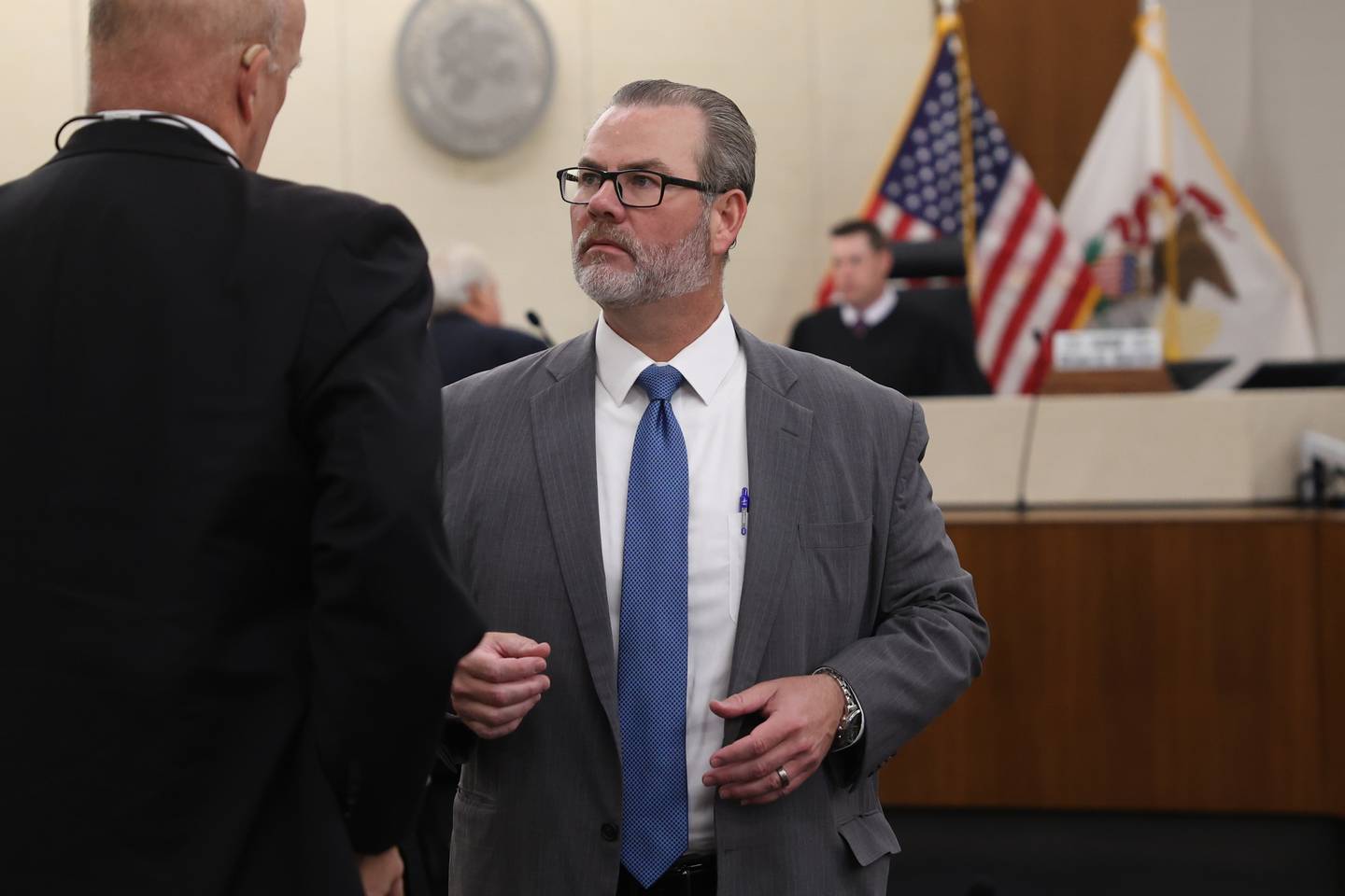 Defense attorney Robert Bodach talks with prosecuting attorney Bill Elward at a pretrial meeting for his client Edward Goewey. Goewey, a Will County Deputy, is on trial for disorderly conduct after he allegedly yelled at school officials and threatened to personally remove a child believed to have made a threat to shoot students at St. Mary Catholic School in Modena. Tuesday, Aug. 9, 2022, in Joliet.