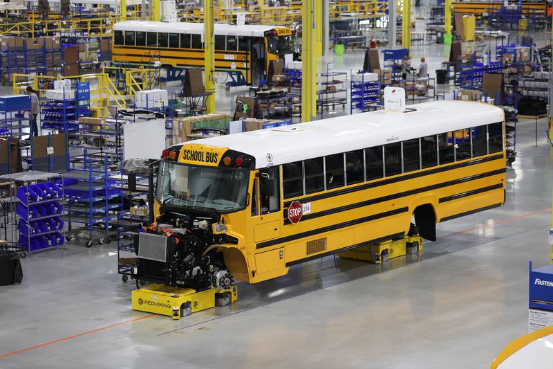 A bus sits elevated at the Lion Electric manufacturing facility on Friday, July 21st, 2023 in Joliet.