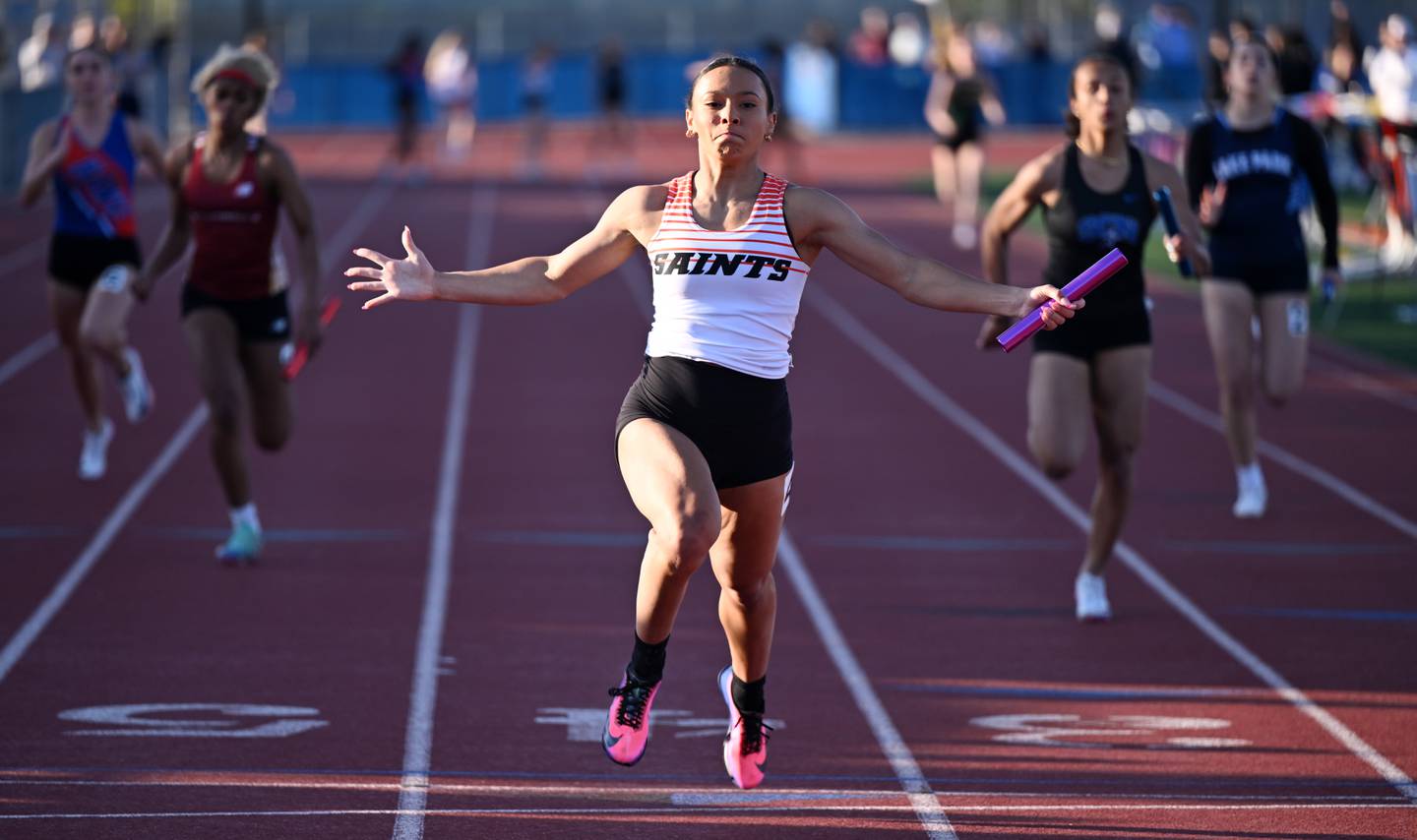 St. Charles East’s Madeline Piekarz crosses the finish line as the Saints win the 400-meter relay during the Class 3A Hoffman Estates girls track and field sectional on Thursday, May 14, 2026 in Hoffman Estates.