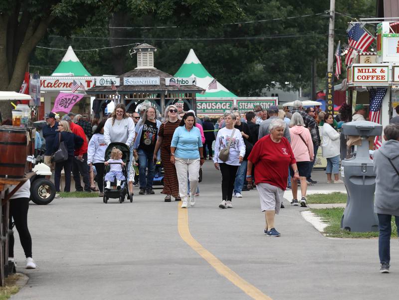 Crowds walk down one of the main pathways Wednesday, Sept. 3, 2025, on opening day of the Sandwich Fair.