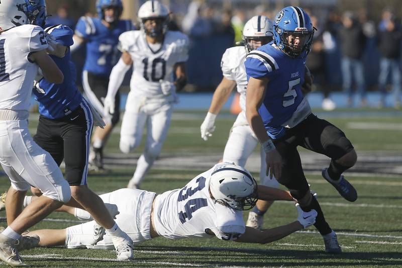 Cary-Grove's Jack Rocen tries to tackle Lake Zurich's Lucas Lappin during a IHSA Class 6A semifinal playoff football game on Saturday, Nov. 18, 2023, at Lake Zurich High School.