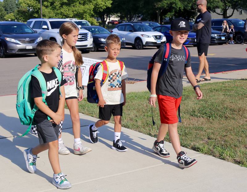 Tucker Dienst, Mia Smith, Matthew Smith and Ryder Dienst walk to their first day of school at Kaneland John Stewart Elementary in Elburn on Wednesday, Aug. 14, 2024.