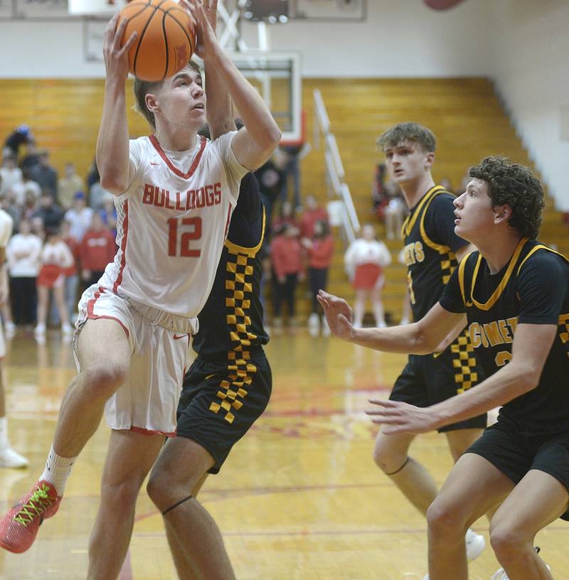 Streator’s Riley Steven’s beats Reed Custer’s Eddie Bryan to the net for a layup in the 1st period Tuesday at Streator.