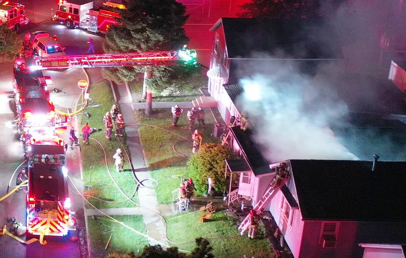 Firefighters work the scene of a structure fire in the 100 block of West Cleveland Street on Thursday, May 15, 2025 in Spring Valley. The fire broke out shortly before 8:30p.m. Fire departments from La Salle Bureau and Putnam Counties responded to the scene. One firefighter was injured at the scene. A mutual aid box alarm system (MABAS) call was issued prompting the response.
