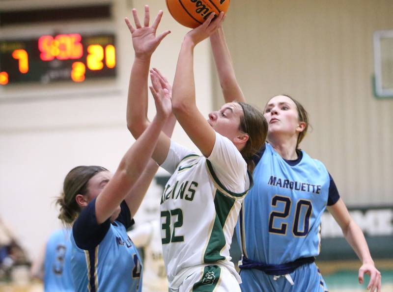 St. Bede's Quinn McClain pulls up in the lane to sink a shot over Marquette's Hunter Hopkins and teammate Kaitlyn Davis on Monday, Dec. 2, 2024 at St. Bede Academy.