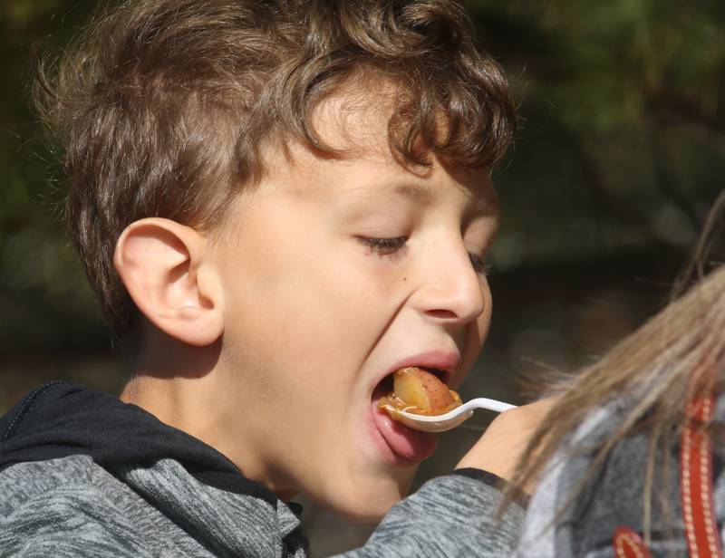Tristan Berlin of Davis Junction tries Burgoo during the 54th annual Burgoo on Sunday, Oct. 13, 2024 downtown Utica.