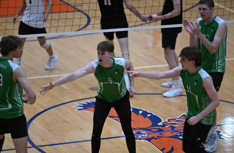York’s Logan Rice, middle, and Zach Brown, right, celebrate a point with Jack Bute during the boys state volleyball quarterfinal match against Lincoln-Way West  at Hoffman Estates High School on Friday, May 31, 2024 in Hoffman Estates.