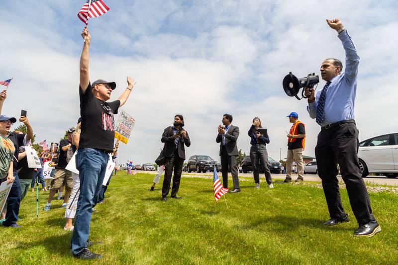 Rep. Raja Krishnamoorthi speaks to protesters during a “No Kings Day” Protest against President Donald Trump’s policies along South Randall Road in Geneva on Saturday, June 14, 2025.