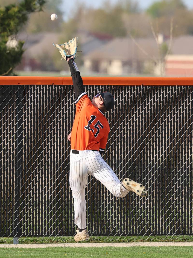 DeKalb's Aaron Rhodes tries to make a catch in left field Monday, April 20, 2026, during their game against Waubonsie Valley at DeKalb High School.