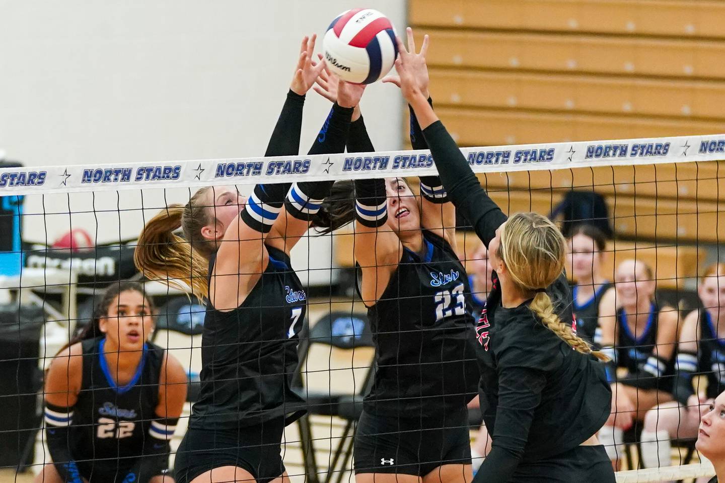 St. Charles North's Mia McCall (left) and Haley Burgdorf (23) defend the net against a kill attempt by Huntley’s Summer Massow (12) during a non-conference match at St. Charles North High School on Wednesday, Sept. 3, 2025.