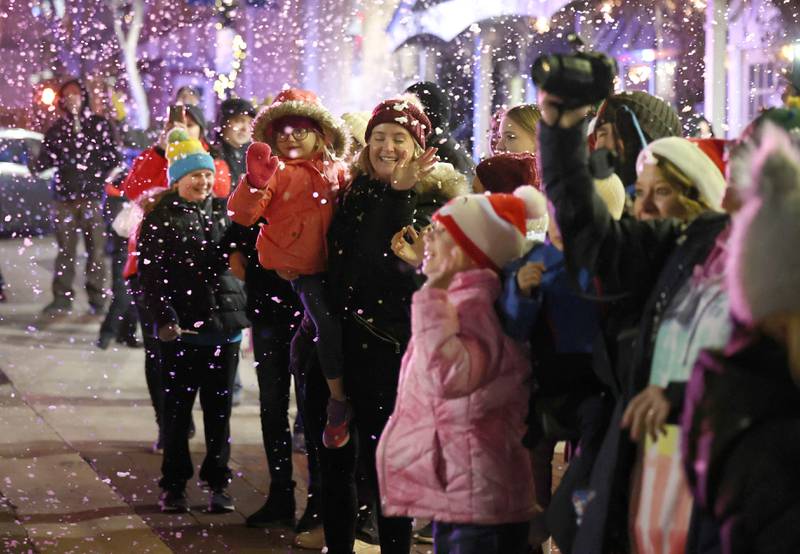 Snow falling from the marquee of the Egyptian Theatre sets the mood for visitors as Santa approaches Thursday, Dec. 1, 2022, during the DeKalb Chamber of Commerce Lights on Lincoln and Santa Comes to Town.