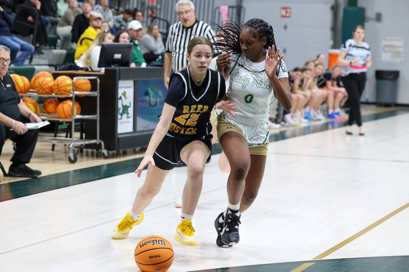 Reed-Custer's Avah Thompson drives against Bishop McNamara's Mahlyia Johnson during Bishop McNamara's 60-36 victory over Reed-Custer in the IHSA Class 2A Bishop McNamara Regional semifinals on Monday, Feb. 16, 2026.