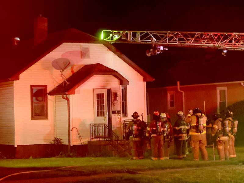 Firefighters gather around a home in the 500 block of West Erie Street for a structure fire on Monday, May 4, 2026 in Spring Valley. The fire happened shortly before 10:45p.m. A Mutual Aid Box Alarm System (MABAS) call was dispatched for additional fire departments from Eastern Bureau County, Peru, Utica, Oglesby and La Salle.