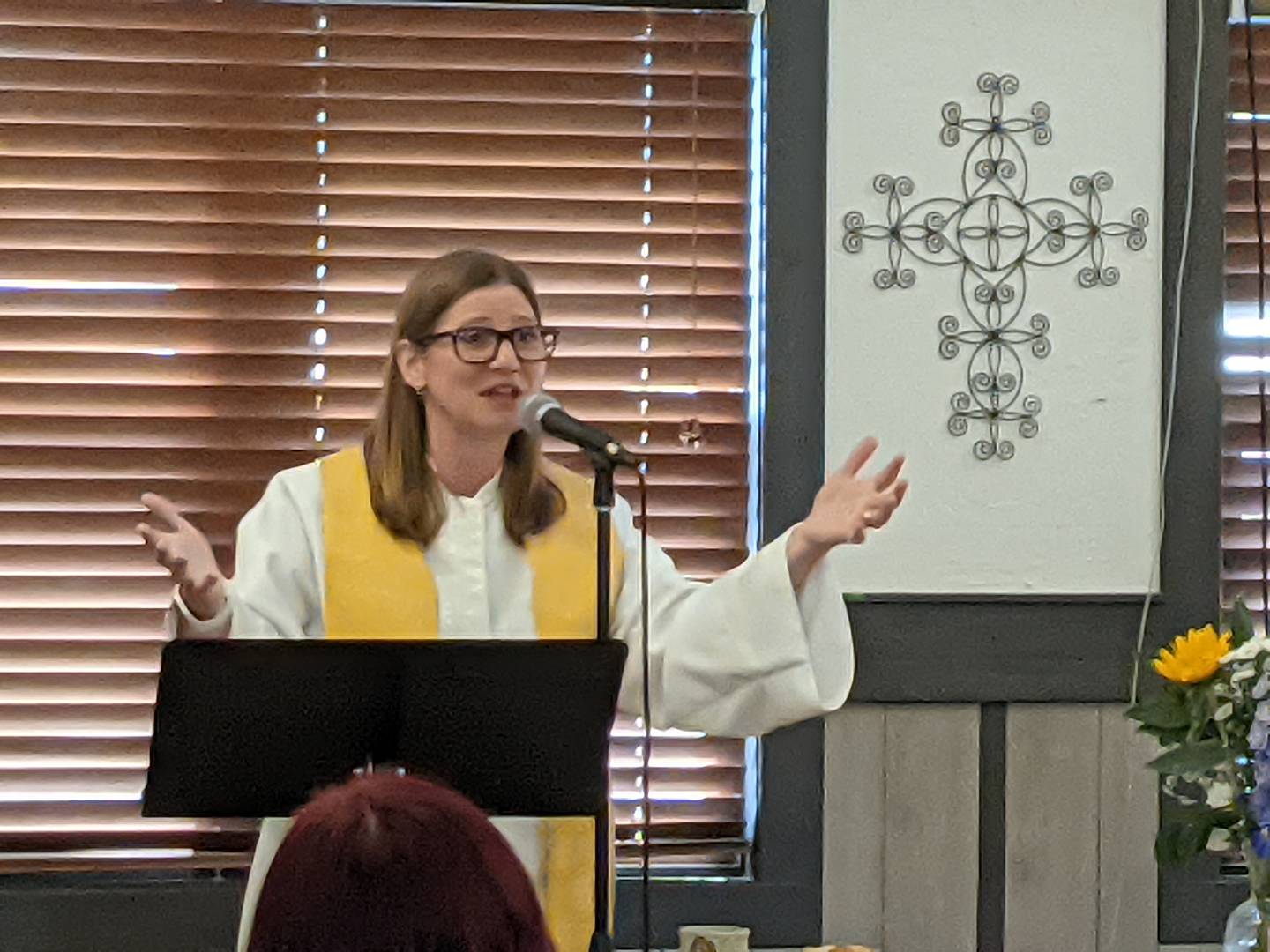 The Rev. Laura Tarro addresses the congregation of Bethany Covenant Church during Sunday's Easter service. The church is located inside of Dimple's Donuts in St. Charles.