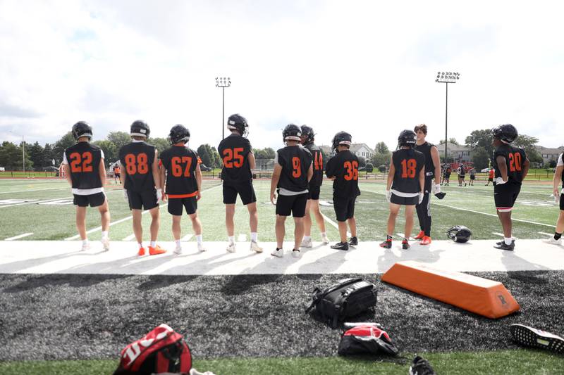 St. Charles East players on the sideline during the first day of practice for the fall season on Monday, Aug. 7, 2023 at the school.