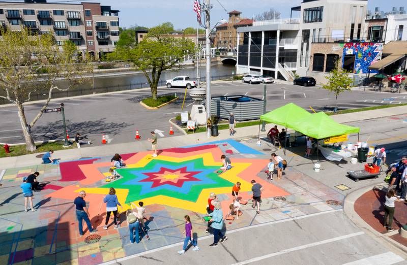A multi colored street mural comes to life at the intersection of Walnut and Riverside Avenues during the St. Charles Art Council’s “Paint the Riverside” event on Saturday, May 10, 2025 in St. Charles.