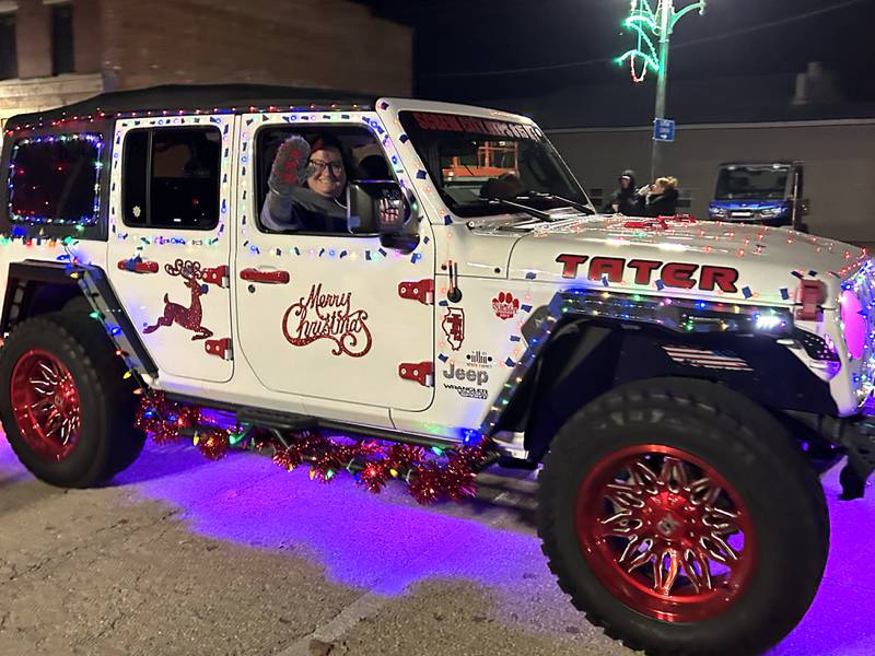 A decorated Jeep travels down Wesley Ave. in the lighted parade during Mt. Morris' Christmas in the Village on Saturday, Dec. 7, 2024.