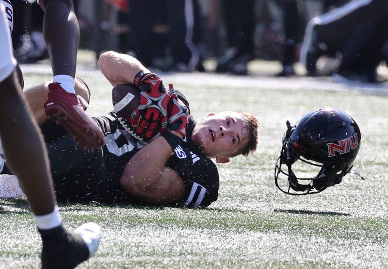 Northern Illinois' Kacper Rutkiewicz loses his helmet after a tackle by a Southern Illinois defender during their game Saturday, Sept. 9, 2023, in Huskie Stadium at NIU in DeKalb.