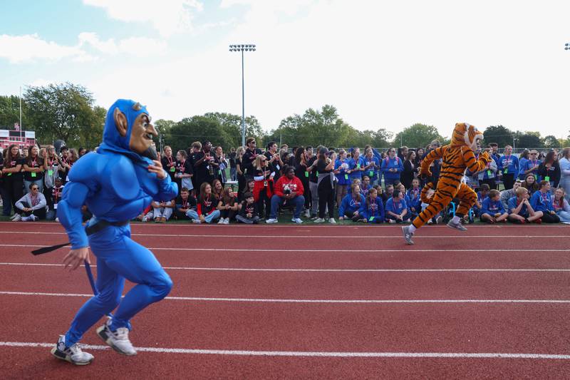 Participants watch as mascots from Peotone, left, and Herscher compete with other schools in a race during the annual Boilermaker Games, hosted by the Best Buddies club on Wednesday, Oct. 8, 2025.