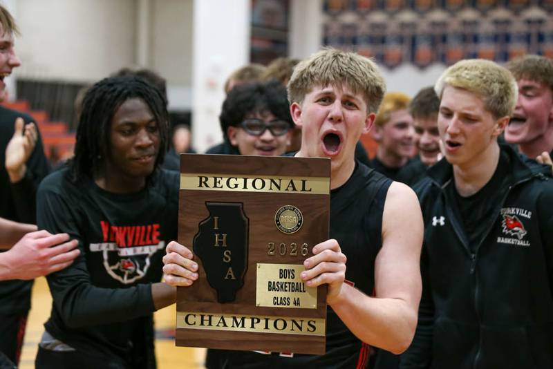 Yorkville celebrates with the Class 4A Regional Championship plaque after defeating Downers Grove South Feb 27, 2026 in Naperville.