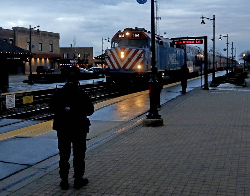 People wait for the Metra train to arrive from Chicago on Tuesday, Feb. 14, 2023, at the Crystal Lake Metra station in downtown Crystal Lake.