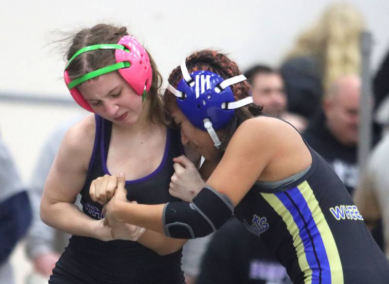 Hampshire’s Annabelle Mueller, left, battles Wheeling’s Haydee Cruz at 105 pounds in Whip-Pur Women’s Classic varsity girls wrestling on Saturday, Dec. 20, 2025, at Hampshire High School in Hampshire.