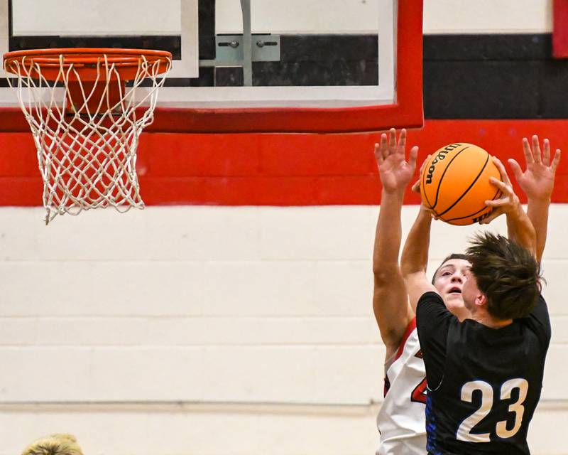 Riverside Brookfield's Noah Van Tholen (23) makes a basket during the game while being defended by Glenbard East's Michael Nee (4) on Friday Dec. 19, 2025, held at Glenbard East High School.
