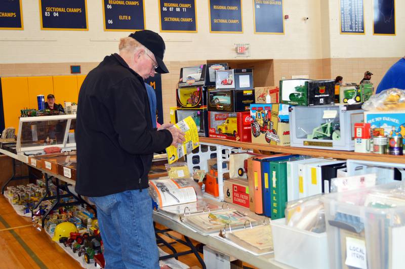 Delbert Yocum, of Franklin Grove, looks through a John Deere pamphlet for sale at the Polo Lions Club’s 38th Farm Toy Show. The event was held at Polo Community High School on March 4.