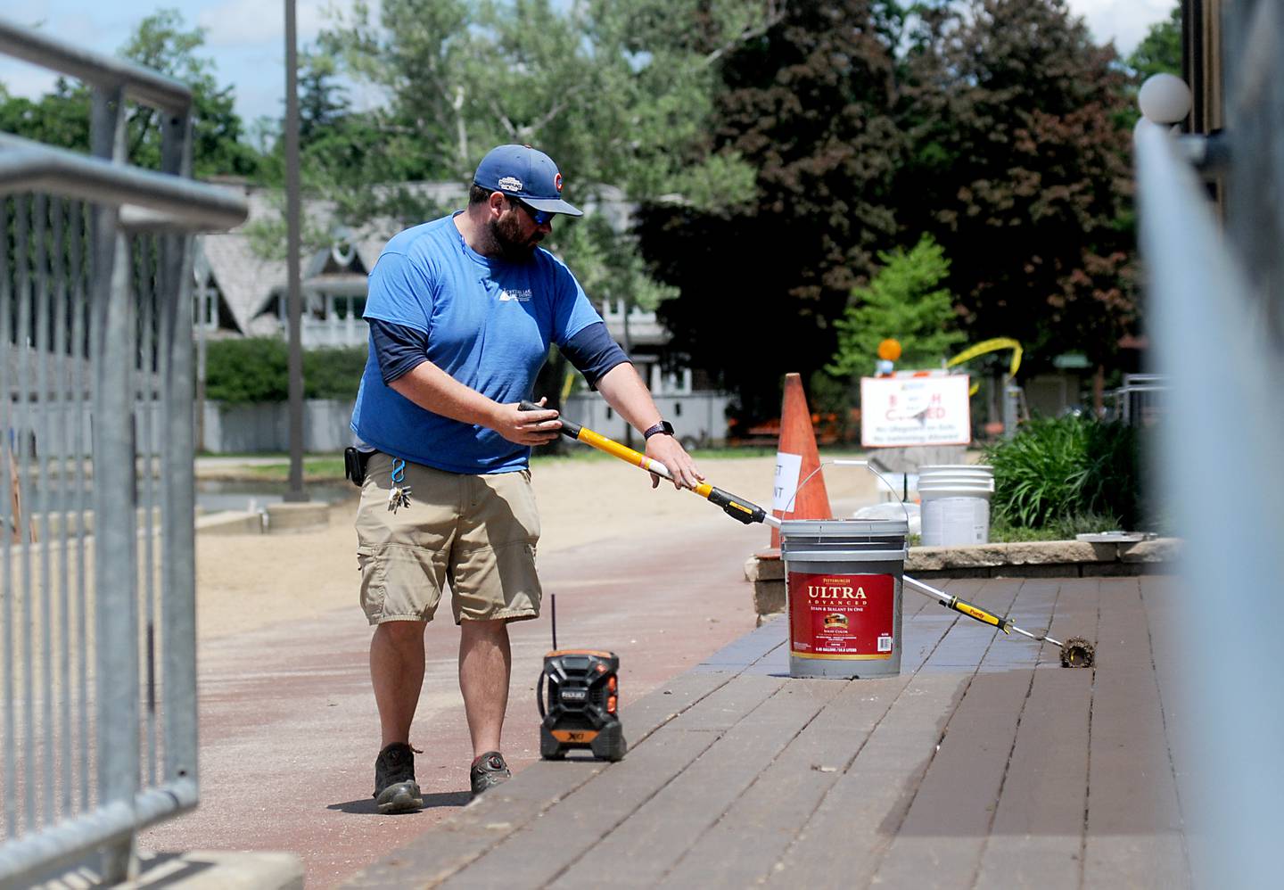 Andrew Dierking, a maintenance worker from the Crystal Lake Park District, paints decking Monday, May 23, 2022, at Crystal Lake's Main Beach, 300 Lakeshore Drive, in Crystal Lake, as they work on preparing the beach to open on Friday, May 27. With summer here, McHenry County park districts are seeing their rosters fill out for its programming.
