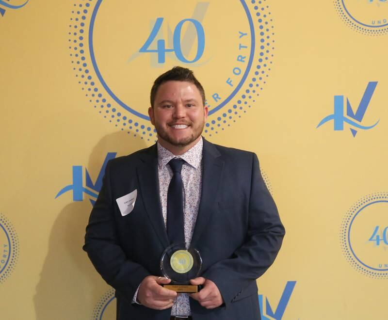Gabriel Leonard poses for a photo with his award during the 40 Under Forty awards banquet on Thursday, March 21, 2024 at Westclox in Peru.