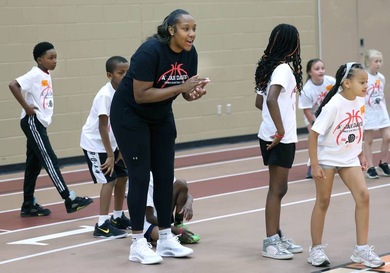 DeKalb native and former Northern Illinois University basketball player A'Jah Davis cheers on participants Saturday, May 24, 2025, during her A'Jah Davis Foundation Basketball Camp and Wellness Day at DeKalb High School.