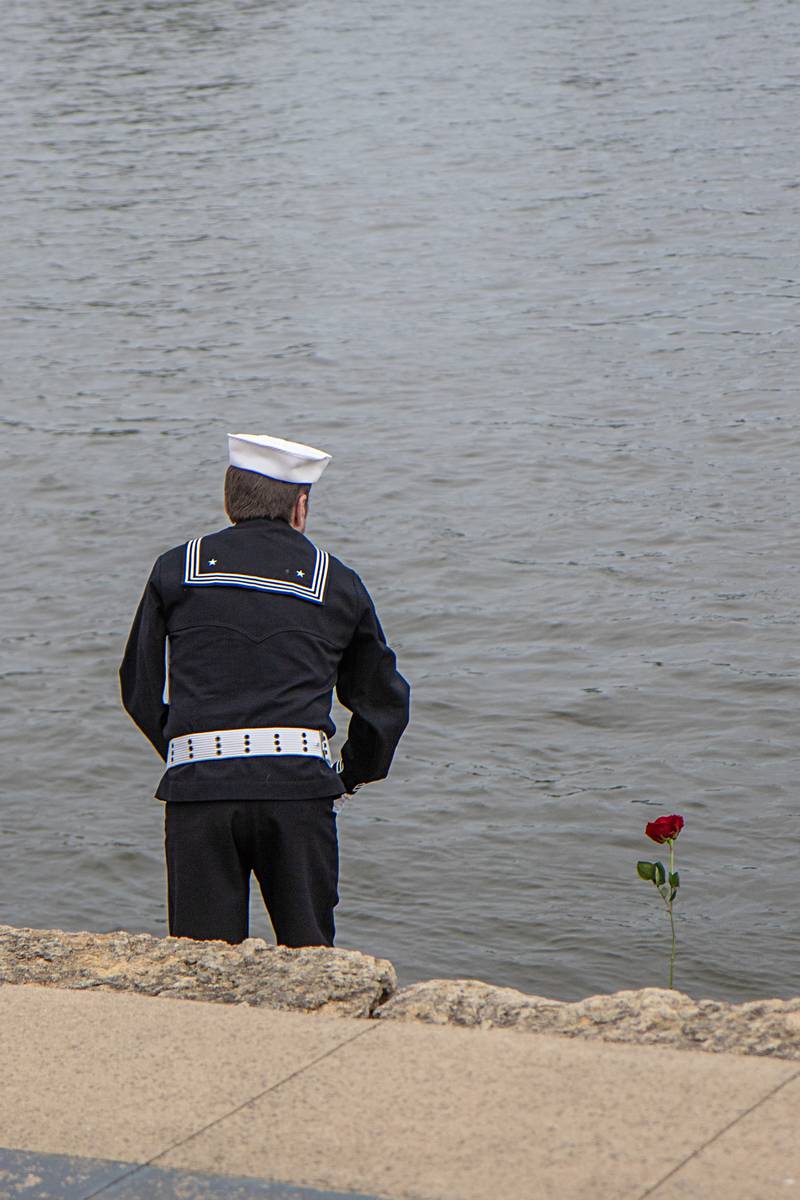 Flowers are tossed into the Rock River to honor those who lost their lives at sea during a Dixon Memorial Day service Monday, May 29, 2023.