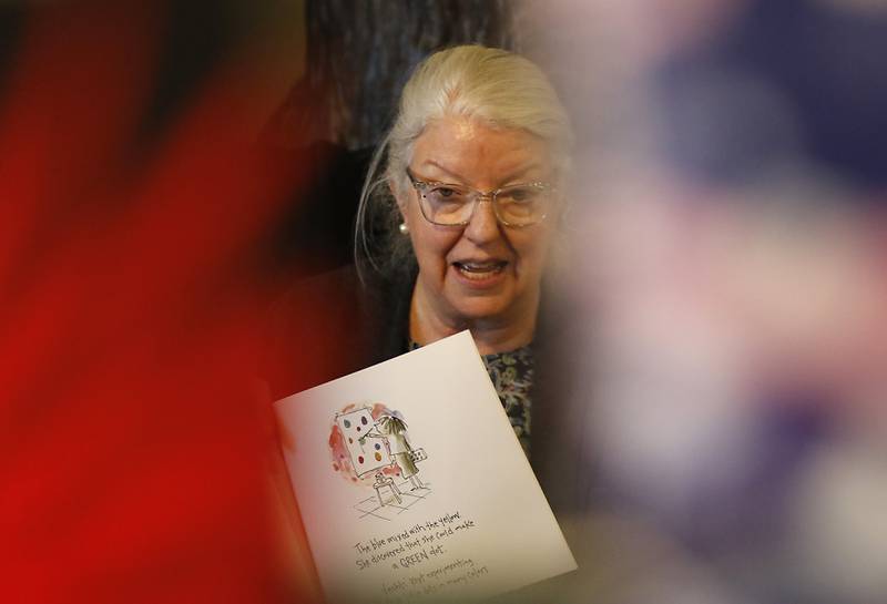 Bette Chwalisz, a retired teacher, reads a book Thursday, Feb, 20, 2025, at Read Between The Lynes in Woodstock during the bookshop's weekly story time.