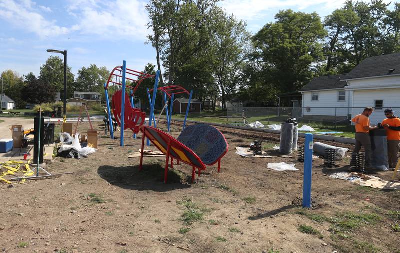 Crews from Build LLC Custom Playgrounds construct a ninja obstacle course located south of the splash pad on Thursday, Oct. 2, 2025 in Washington Park in Peru. The city will also be installing ice rink chillers soon for the upcoming winter season.