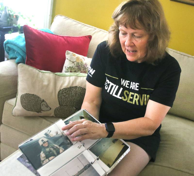 U.S. Army Veteran Laurie Emmer, who served in Afghanistan, points out a photo Thursday Aug. 19, 2021, of herself during her time in Afghanistan. She is worried about some of the people she met there, especially women, as the U.S. pulls out of the region amid the Taliban advances