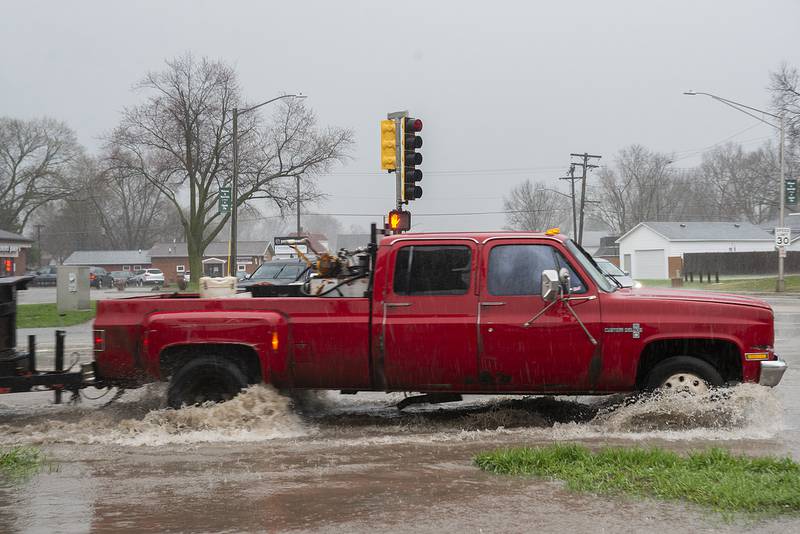 Rain floods the streets of Rock Falls Friday, April 22, 2022. The Sauk Valley was hit with a deluge of rain and high winds.