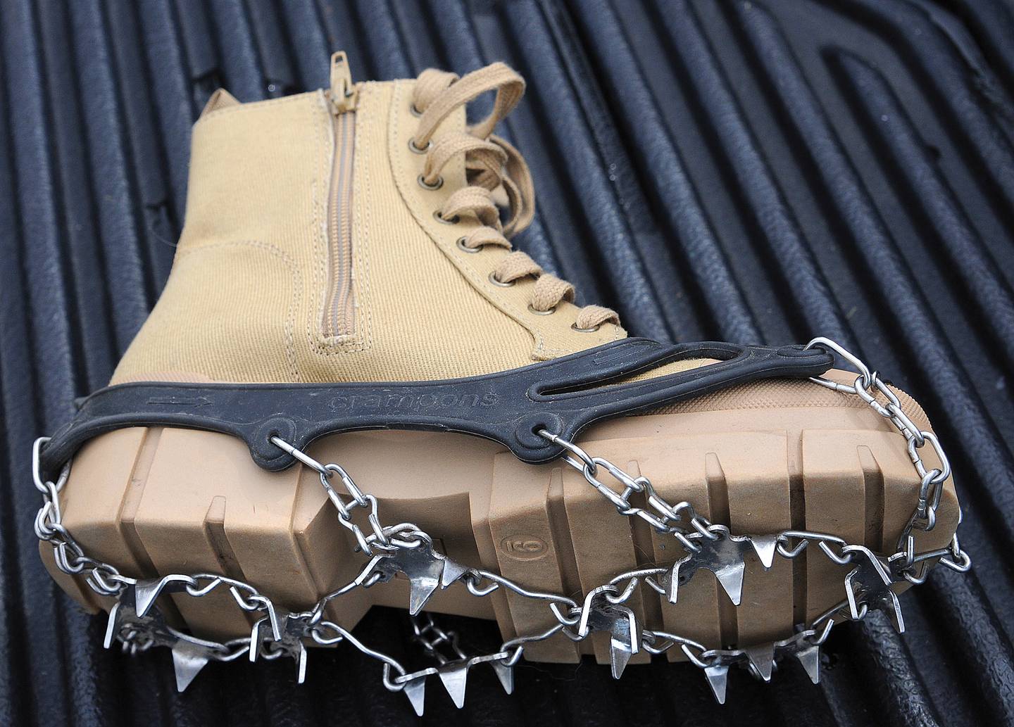 Traction devices such as crampons attach to footwear and ease navigation across snowy and slick surfaces.