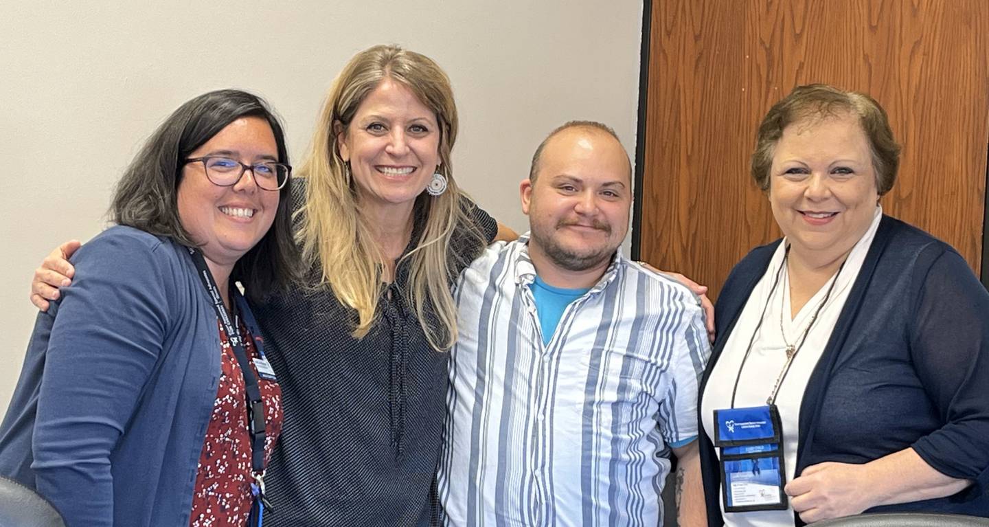 (From left) Advocacy Coordinator and Trainer Bobbi Jo Mayszak, Advocate Volunteers Laura Nash and Riley Kozak, and Executive Director Sally M Van Cura pose for a photo after a swearing-in ceremony.